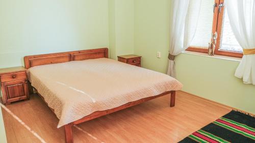 a small bedroom with a bed and a window at The Sunny Guest House of Veliko Tarnovo-Amazing View, Top Location in Veliko Tŭrnovo