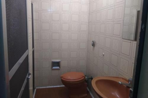 a bathroom with a toilet and a sink at Hotel Barão De Tefé in Rio de Janeiro