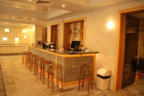 a bar with a row of stools in a kitchen at 7 Pools SPA Boutique Hotel in Bansko