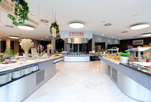 a buffet line in a restaurant with food at Hotel Gran Bilbao in Bilbao
