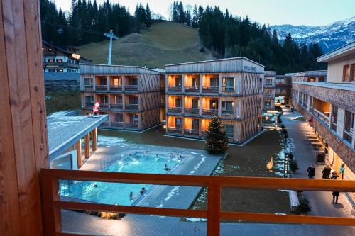 a view from a balcony of a hotel with a swimming pool at Tirol Lodge in Ellmau
