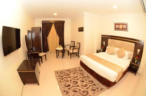 A bed or beds in a room at Al Masem Luxury Hotel Suites 3 Al Ahsa