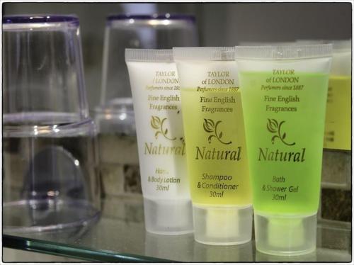 three bottles of natural moisturizers sitting on a shelf at The Old Mill Bed and Breakfast in Bere Regis