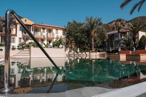 a swimming pool in front of some buildings at Hotel Karbel Sun in Oludeniz