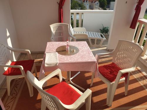 a table and chairs sitting on a balcony with a table and chairs at Apartments & Rooms Zlatica Hvar in Hvar