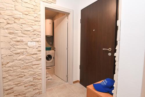 a hallway with a stone wall and a door to a bathroom at Bijela- Idylle in Bijela
