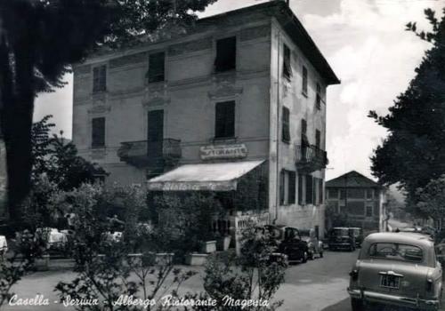 an old photo of a building with a car parked in front at Albergo Magenta in Casella