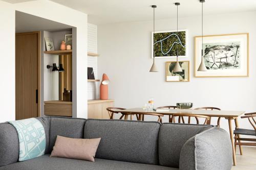 a living room with a couch and a table at PURO Kraków Kazimierz in Kraków