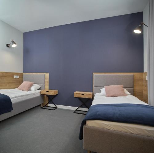 Posteľ alebo postele v izbe v ubytovaní Apartamenty Queen