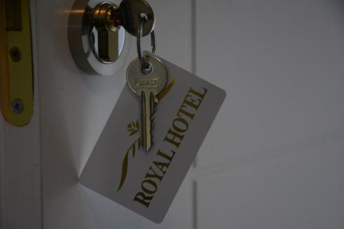 a tag on a door with a key on it at Royal Hotel Peshkopi Albania in Peshkopi