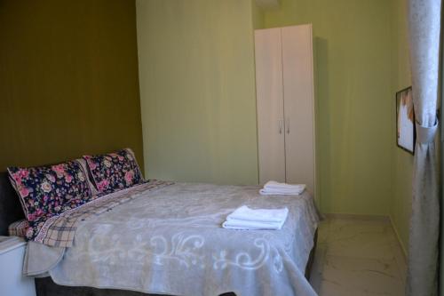 a bedroom with a bed with towels on it at Royal Hotel Peshkopi Albania in Peshkopi