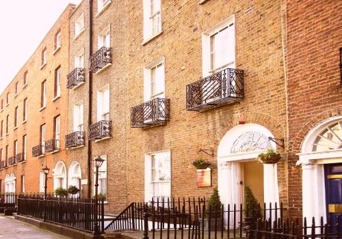 ein Backsteingebäude mit Fenstern und Balkonen darauf in der Unterkunft Baggot Court Townhouse in Dublin