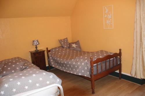 a bedroom with two beds in a room at Suite dans les dépendances du Château in Agonges