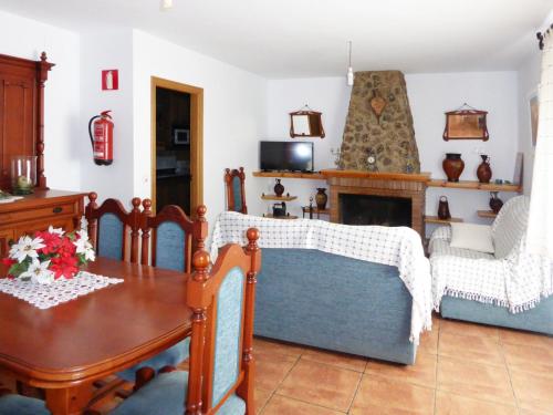 a living room with a table and a fireplace at Vivienda rural casa manoli 