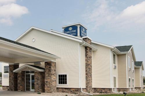 a building with a sign on top of it at Cobblestone Inn & Suites - Linton in Linton