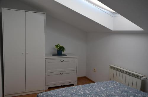 a bedroom with a bed and a dresser and a skylight at Agroturystyka Czekaj przy Suntago in Lublinów