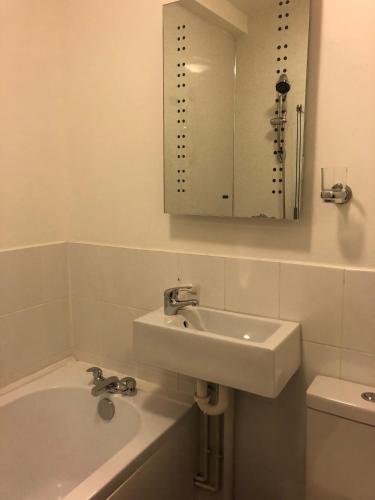 a white bathroom with a sink and a mirror at Pickmere Country House in Pickmere