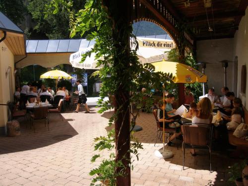 a group of people sitting at tables in a restaurant at Gasthof Goldene Traube in Golling an der Salzach
