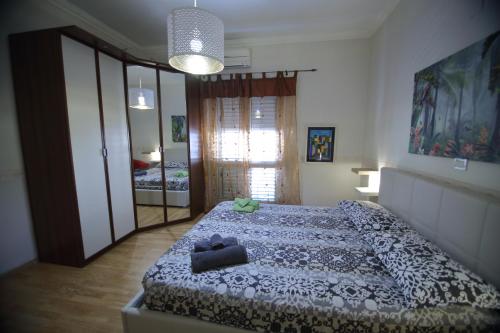 a bedroom with a bed with a teddy bear on it at CASA DI MIMMA casa vacanze in Reggio Calabria