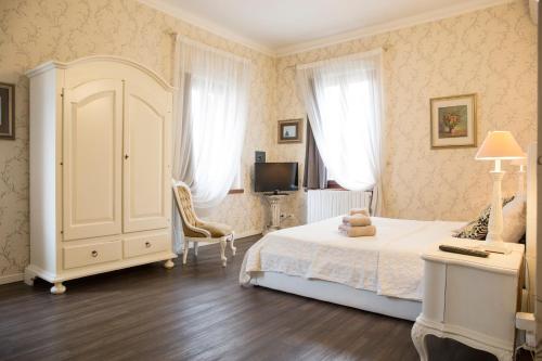a bedroom with a bed and a desk and a tv at Miglioranzi Apartments in Verona