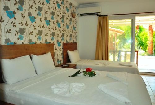 a hotel room with two beds with flowers on it at Durak Hotel ölüdeniz in Oludeniz
