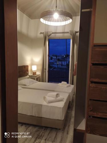 a bedroom with a bed and a window with a view at Galaxidi Sea View Apartment , Galaxidi in Galaxidhion