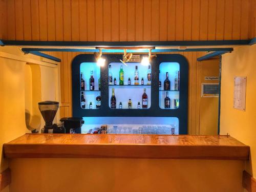 a bar with a lot of bottles of alcohol at Pensao Residencial Flor dos Cavaleiros in Lisbon