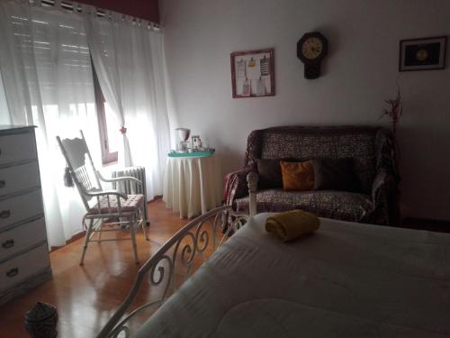 a bedroom with a bed and a couch and a chair at Mi Lugar en el Mundo in Buenos Aires