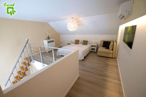 a bedroom with a bed and a staircase in a room at My Cocoon in Court-Saint-Étienne