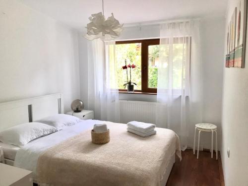 a white bedroom with a bed and a window at AmurguluiBnB 3-Bedroom Bucegi Mountains Retreat in Buşteni