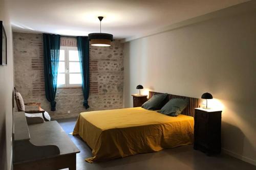 een slaapkamer met een geel bed en een raam bij Gîte de charme du Domaine Pagnon Guillemette in Torreilles