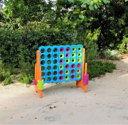 a giant lego game is sitting on the sidewalk at Bayside Inn Key Largo in Key Largo