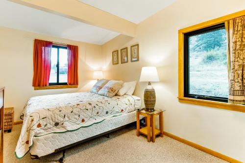 a bedroom with a bed and a window at On The River in Estes Park