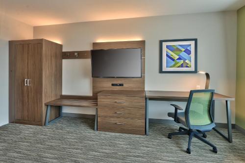 an office with a desk and a tv and a chair at Holiday Inn Express & Suites - Albuquerque East by IHG in Albuquerque