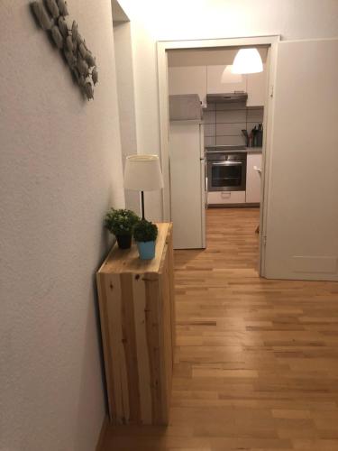 een kamer met een tafel met een lamp en een keuken bij Mida Gästehaus in Freiburg im Breisgau