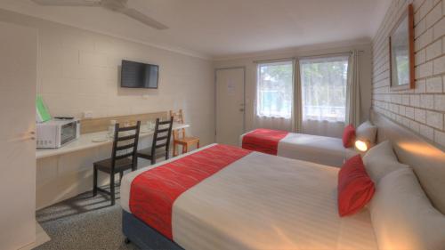 a hotel room with two beds and a kitchen at Boonah Motel in Boonah