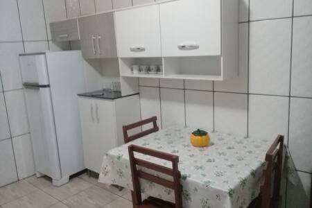 a small kitchen with a table with a pineapple on it at Villa Maria DA Luz ROCHA CASA D in Olímpia