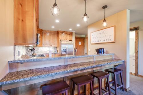 a kitchen with a large counter with stools at Trail Head Lodge # 302 in Cle Elum