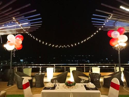 a table with red and white balloons on a balcony at Phung Hung Boutique Hotel in Phu Quoc