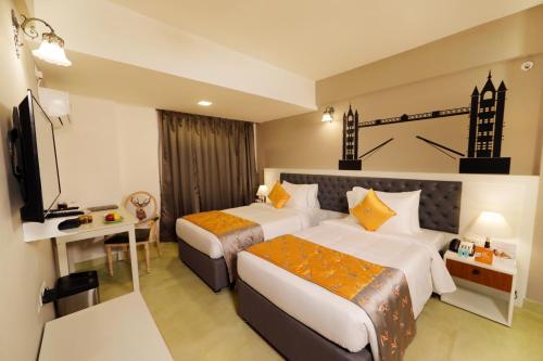 A bed or beds in a room at The Altruist Business Hotel Whitefield