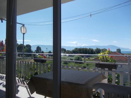 a balcony with a table and a view of the mountains at Marko Apartments in Struga
