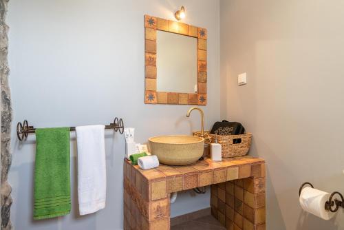 a bathroom with a sink and a mirror at Casa Leonor by Rent2U, Lda in Arco da Calheta