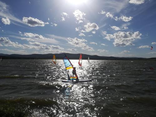 a group of people windsurfing on a body of water at Apartmán Life in Nature in Jaronice