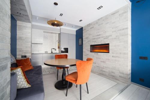 a dining room with a table and orange chairs at Lviv4U in Lviv