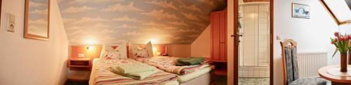 a bedroom with a bed with a cloud painted ceiling at Pension Grünes Herz in Tonndorf