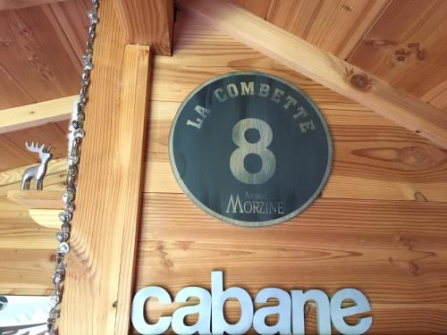 a clock on the wall of a restaurant at la Cabane dans les Arbres in Saint-Jean-dʼAulps