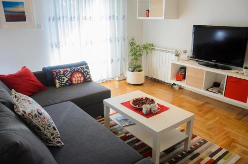 a living room with a couch and a coffee table at Dunavski Kej in Smederevo