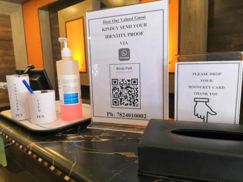 a bathroom counter with a bottle of soap and a box at Hotel Benzz Park Vellore in Vellore