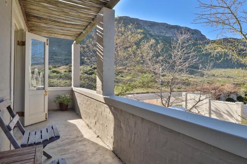 a balcony with a view of a mountain at Hermanus Lodge on the Green - Solar Power in Hermanus