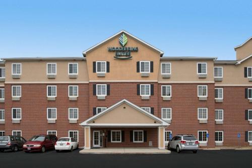 a large building with cars parked in front of it at WoodSpring Suites St Louis Arnold in Arnold